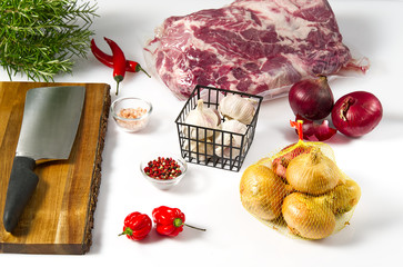 Fresh Onion isolated on white table with Garlic and raw pork meat in vacuum. Healthy Cooking industry concept