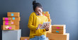 © sutthinon602 - Startup small business SME, Entrepreneur owner using smartphone or tablet taking receive and checking online purchase shopping order to preparing pack product box. Selling online ideas concept
