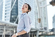 © pkrn - A beautiful Asian business woman is walking in a business district.