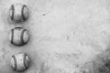 Baseball border in black and white with copy space by old used game balls.