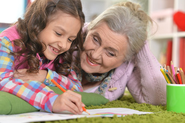 Sticker - Portrait of grandmother and granddaughter drawing together