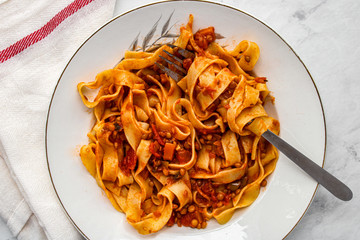 Wall Mural - Tagliatelle pasta with lentil bolognese. Vegetarian bolognese sauce. Top view. 