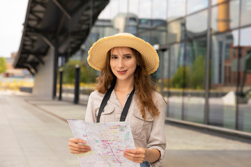 A female carefully studies the map of the city.