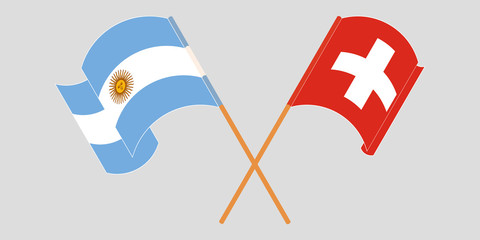 Crossed and waving flags of Switzerland and Argentina