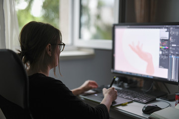 Wall Mural - Graphic designer  wearing glasses working remotely from PC