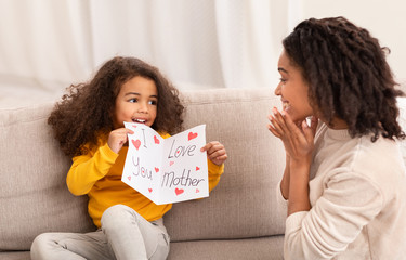 Wall Mural - Daughter Congratulating Mother On Birthday Giving Self-Made Postcard At Home