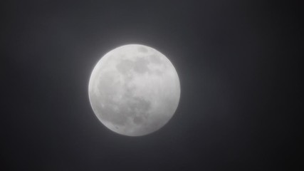 Wall Mural - full moon moving between clouds