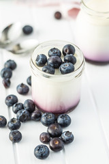 Canvas Print - White fruity yogurt in jar and blueberries.