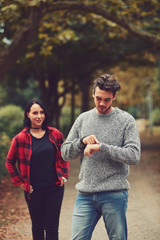 Wall Mural - Young man waiting for his lady and checking time. Love concept.