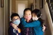 © Carrie Yuan - Portrait of Asian siblings wearing homemade masks in isolation