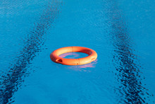 Orange Lifebuoy Floating On A Pool