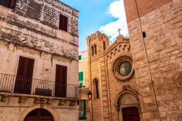 Wall Mural - Church of Santa Maria Assunta between other old buildings, old architecture in Fasano, Province of Brindisi, Apulia, Italy, high section street view