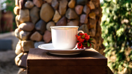 Wall Mural - white porcelain cup and saucer and red quince flowers in the spring garden