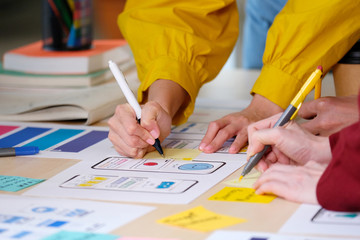 Wall Mural - brainstorm planing creative asian teamwork, close up of hands mobile phone app developer team meetin