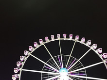Low Angle View Of Illuminated Ferris Wheel Against Sky At Night