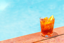 Negroni Cocktail Near A Pool At The Resort Bar Or Suite Patio. Luxury Resort, Vacation, Holiday, Getaway, Summer Time, Room Service Concept. Horizontal With Place For Text