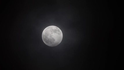 Wall Mural - full moon moving between clouds, 4k