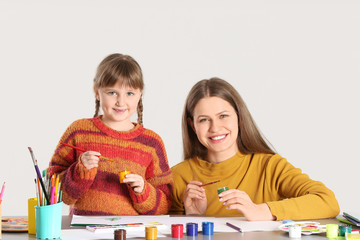 Sticker - Drawing teacher giving private art lessons to little girl on light background