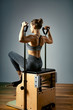 © Georgii - Pilates reformer chair woman fitness yoga gym exercise. Correction of musculoskeletal system, beautiful body. Correct posture