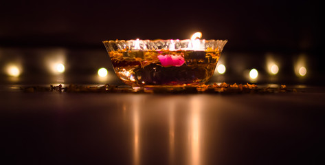 Happy Diwali - rangoli painting on floor for diwali with floating candles
