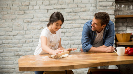 Poster - Young father and his cute daughter making dough at home kitchen