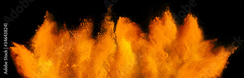 Fotografía orange red holi paint color powder explosion isolated dark black background
