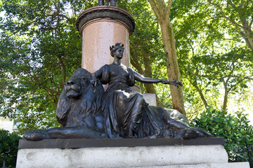 london statue of britannia sitting on a lion at waterloo place