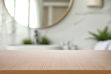 Wall Mural - Empty wooden table and blurred view of stylish bathroom interior