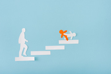 Wall Mural - Top view of paper orange and white men on career ladder on blue