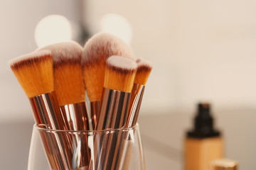 Poster - Decorative cosmetics and tools on dressing table in makeup room, close up