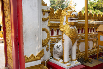 Golden singha statue guardian of Pagoda or Stupa of Wat Phra That Phanom temple for foreign traveler and thai people travel visit and respect praying in Nakhon Phanom, Thailand