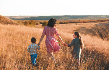 Sticker - woman with children holding hands in field