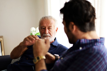 Happiness father and son talking and sharing discussion lifestyle for domestic life protection from COVID-19 virus at home.