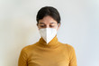 © beavera - Portrait of young woman with respiratory problems wearing a preventive face mask at home. Health and clinic care for young high risk patients with coronavirus. Covid 19 quarantine at home concept.