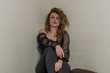© Cliff - Fashion model girl sitting near the wall
