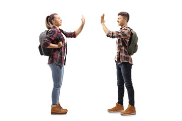 Wall Mural - Students greeting each other with a high-five gesture