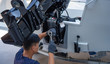 Mechanic is installing speed boat engine , a new engine on an aluminum boat.