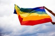 © belyaaa - LGBT flag blown in the wind. Freedom and love concept. Pride month in June.