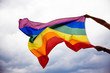 © belyaaa - LGBT flag blown in the wind. Freedom and love concept. Pride month in June.