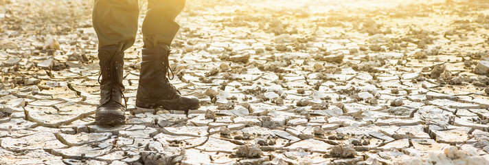 Wall Mural - A man in boots stands in the desert