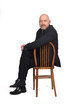 © Curto - portrait of a man sitting on a chair looking at camera on  white background