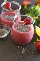 Wall Mural - Berry smoothie with chia seeds on dark background, top view