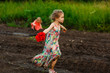 © andrey - little girl goes in dirty dirt road after rain.