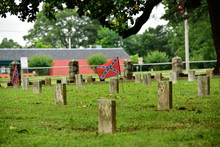 Southern Confederate Cemetery With Gravestones And Union Jack Flags In Georgia