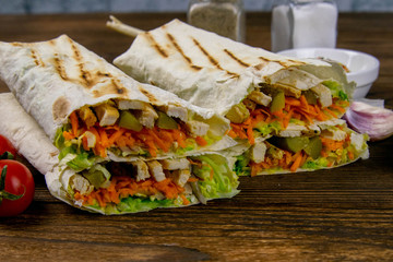 Wall Mural - Homemade shawarma, burrito, chicken roll with vegetables and sauce. Front view ingredients