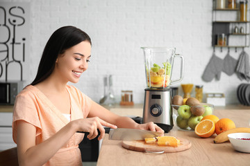 Sticker - Young pregnant woman making fruit smoothie in kitchen at home