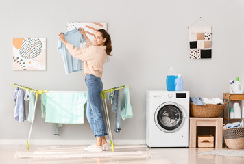 Young woman doing laundry at home