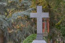 Cross At Cemetery Against Trees