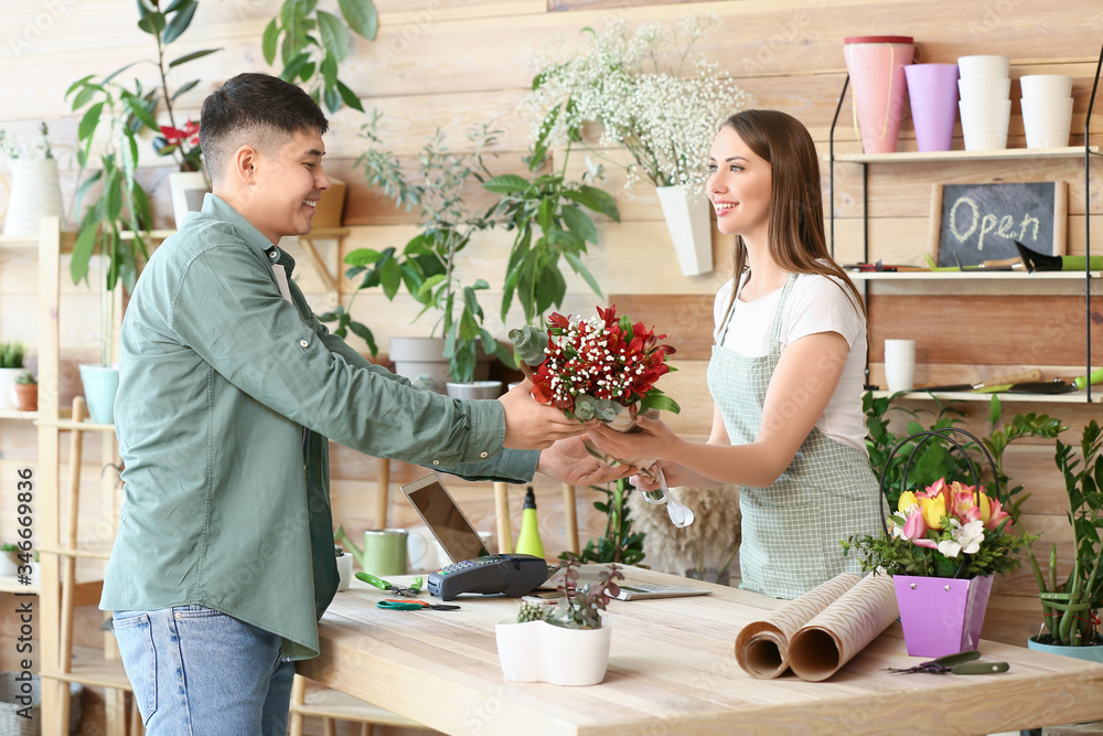 Asian man making order in flower shop