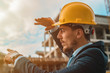 © mahirkart - Young construction engineer with yellow helmet crane and construction background , Turkey,Civil engineer ,construction Plan